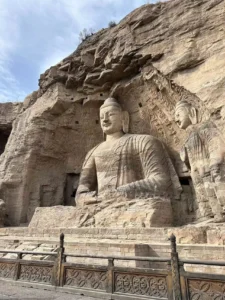 Large Buddha carved into the cliff at Yungang Grottoes in Datong, Shanxi